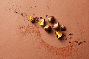 broken chocolate candies with jelly on a brown background