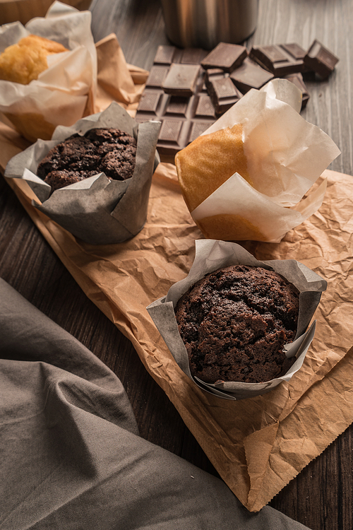 Homemade muffins with chocolate and baking ingredients.