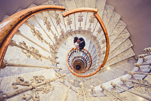 Just married couple together in a spiral staircase