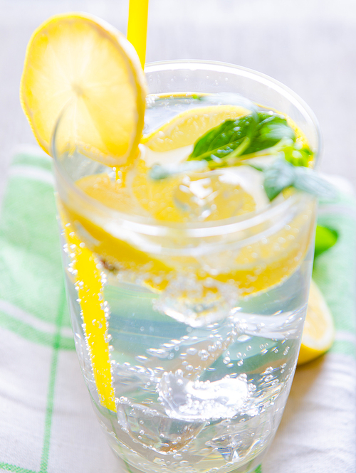 the glasss of mojito with lemon and  straw