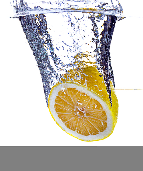 A lemon half is dropped into water against a white background.
