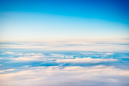 Cloudscape with clear blue sky and fluffy clouds, view from above