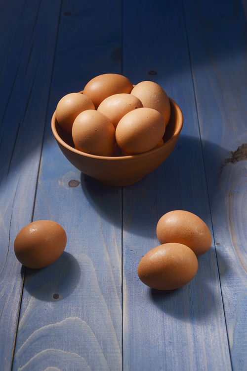 chicken eggs on a dark wooden background