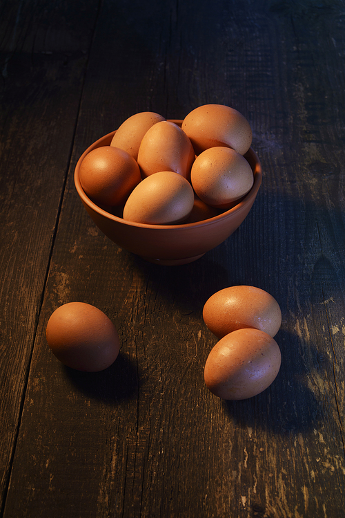 chicken eggs on a dark wooden background