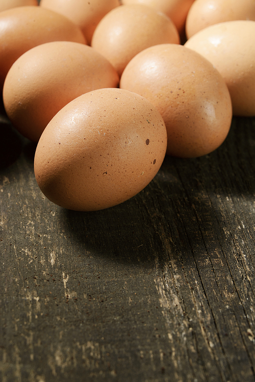 chicken eggs on a dark wooden background