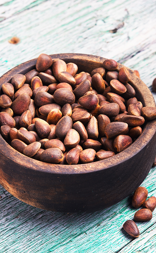 Cedar nuts in a shell in a wooden tub