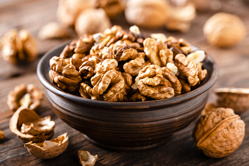 Walnuts. Kernels and whole nuts on wooden rustic table