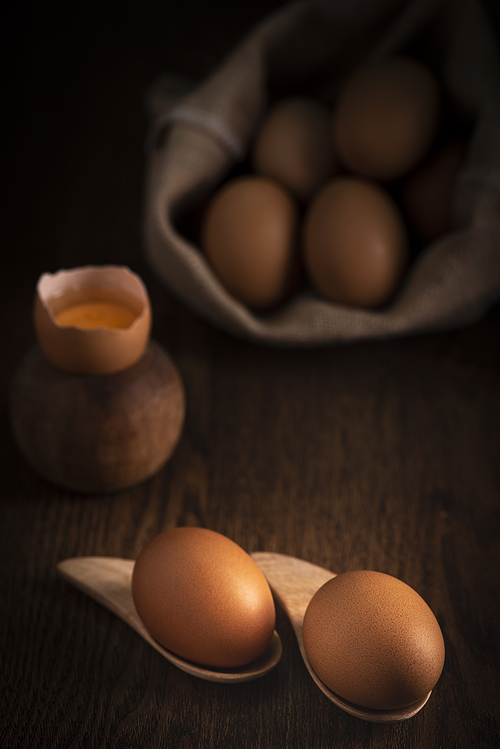 fresh eggs in a basket on wooden table