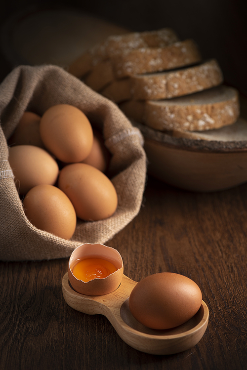 Fresh farm eggs on a wooden rustic background