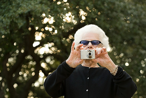 Senior woman taking a photograph