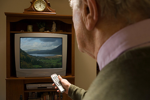 Senior man watching television