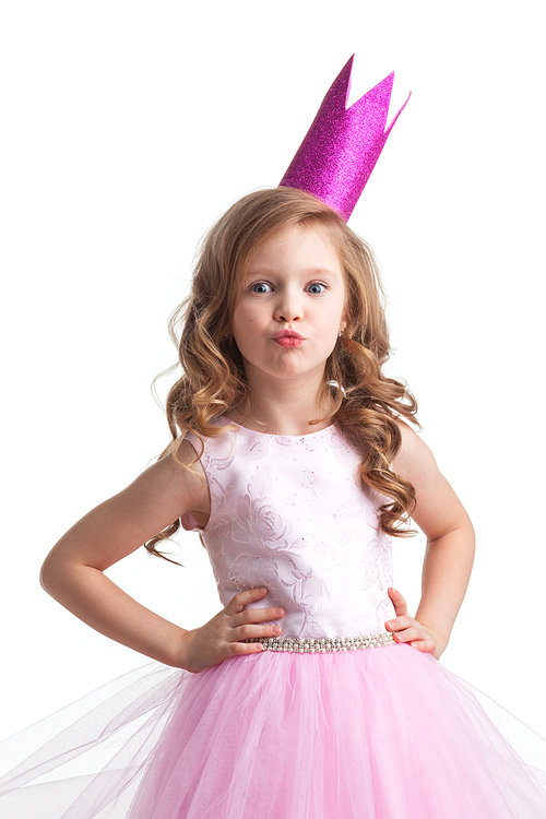 Little princess girl in pink dress and crown giving a kiss , studio isolated on white