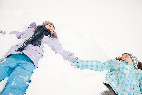 Girls lying in snow