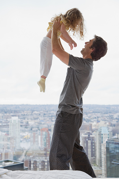 father lifting his daughter