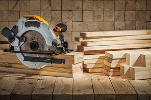 electric corded circular hand saw on wooden background