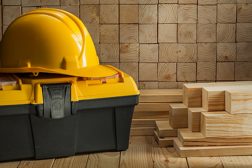 construction helmet on toolbox wooden background