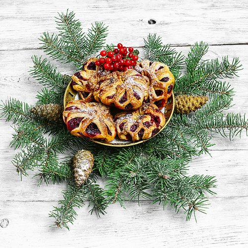 Homemade cookies on plate decorated with fir branches