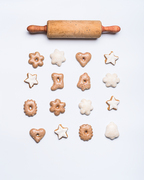 Christmas bake flat lay composition with rolling pin, cookies and  gingerbread on white background, top view. Festive layout or pattern for greeting card