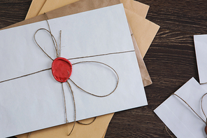 Old post concept with envelopes with wax seal on wooden surface