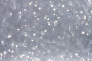 Christmas festives glittering defocused gray background with bokeh lights