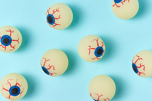 Simbol of Halloween big eyeballs with soft shadows on a light blue background.