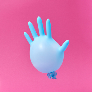 Flying blue rubber surgical glove as a balloon on a hot pink background with copy space. Minimalism concept.