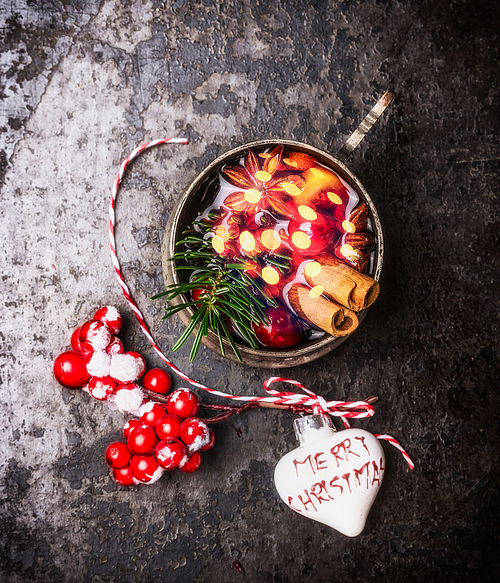 Mug of mulled wine with bokeh  and Christmas decorations, top view