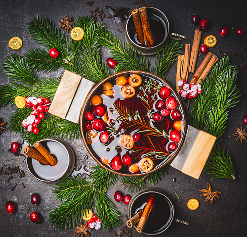 Tasty mulled wine pot with cups and ingredients, top view