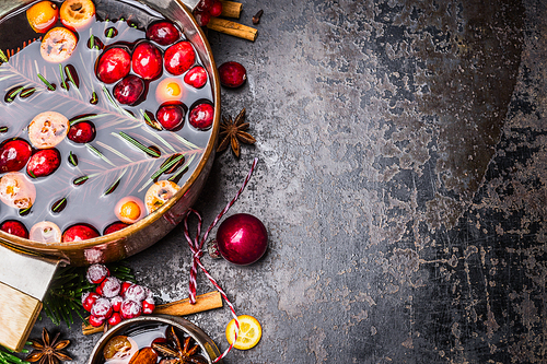 Close up of Pot and mug with mulled wine and Christmas decoration on rustic background, top view, place for text