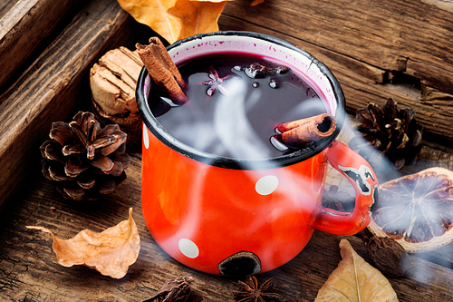 Mulled wine with spices on wooden background.Christmas mulled wine