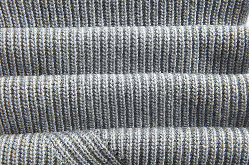 natural warm knitted gray fabric with fabric folds