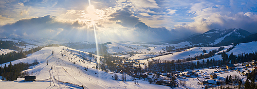 Winter landscape. Panorama of ski resort in Carpathian mountains. Aerial panoramic view. Podobovets village