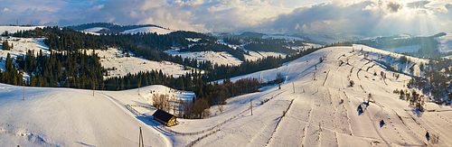 Winter mountain landscape. Panorama of hills and village in Carpathian mountains. Aerial panoramic view. Podobovets and Pilypets villages