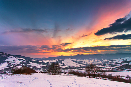 Winter mountain sunset. Fantastic evening winter landscape. Colorful overcast sky in Carpathian range, Ukraine