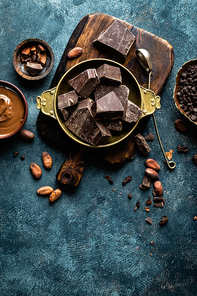 Dark chocolate pieces crushed and cocoa beans. Chocolate background