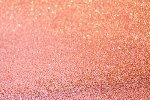 Christmas holiday glittering defocused coral pink background with bokeh lights