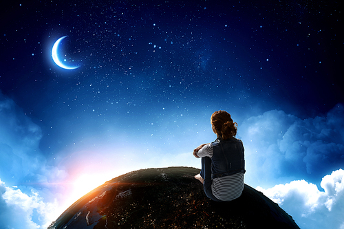 Little girl and big Earth planet. Elements of this image furnished by NASA