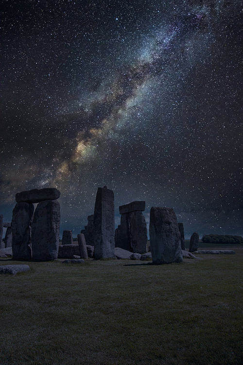 Epic digtial composite image of Milky Way over monolithic standing stones in landscape