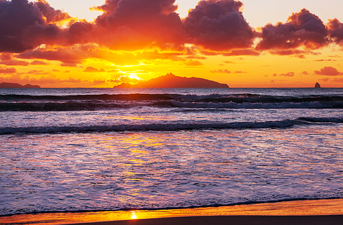 Beautiful Sunset at the Ocean Beach, New Zealand. Inspiring natural and travel background
