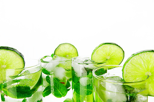 Mojito cocktails with lime and mint isolated on white