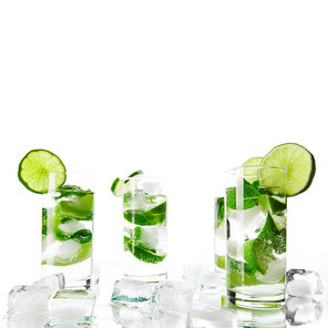 Party mojito cocktails with lime and mint ice cubes isolated on white background
