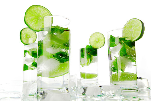 Mojito cocktails with lime and mint isolated on white