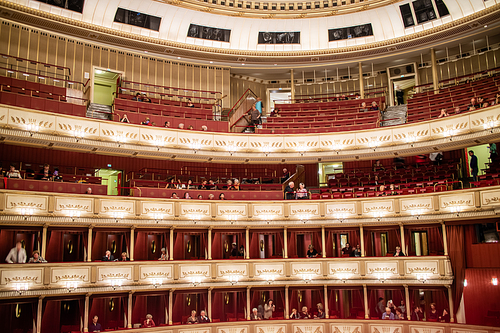View of the interior of the Vienna State Opera auditorium with the audience on balconies before starting performance in Vienna, Austria.
