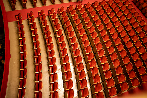 View of the empty parterre in the theatre concert hall of Vienna State Opera auditorium with red seats in the rows without people in Vienna, Austria.