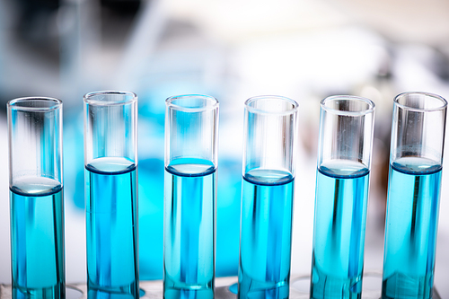 Chemistry laboratory glassware, science laboratory research and development concept, flask, beaker, and test tubes with blue liquid water sample test, scientific test tubes equipment