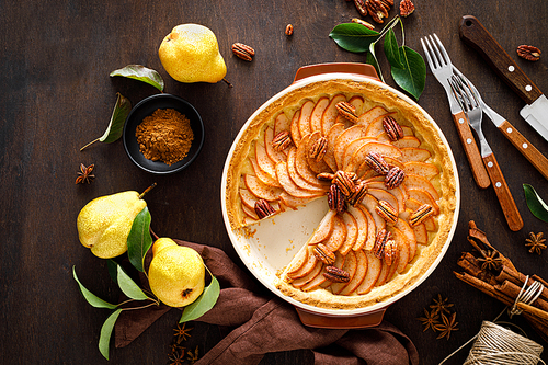 Pear tart, pie or cake with fresh pears, cinnamon and pecan nuts