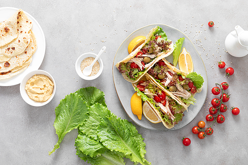 Tacos with chicken meat, salad and vegetables