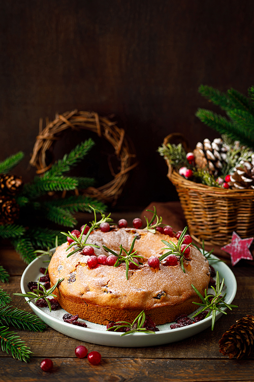 Christmas cranberry fruit cake with decorations on wooden background