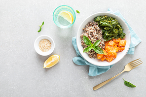 Vegan healthy lunch bowl with quinoa, sauteed kale and baked butternut squash, top down view