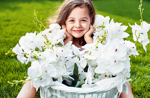 Portrait of a cute smiling girl with a flower basket